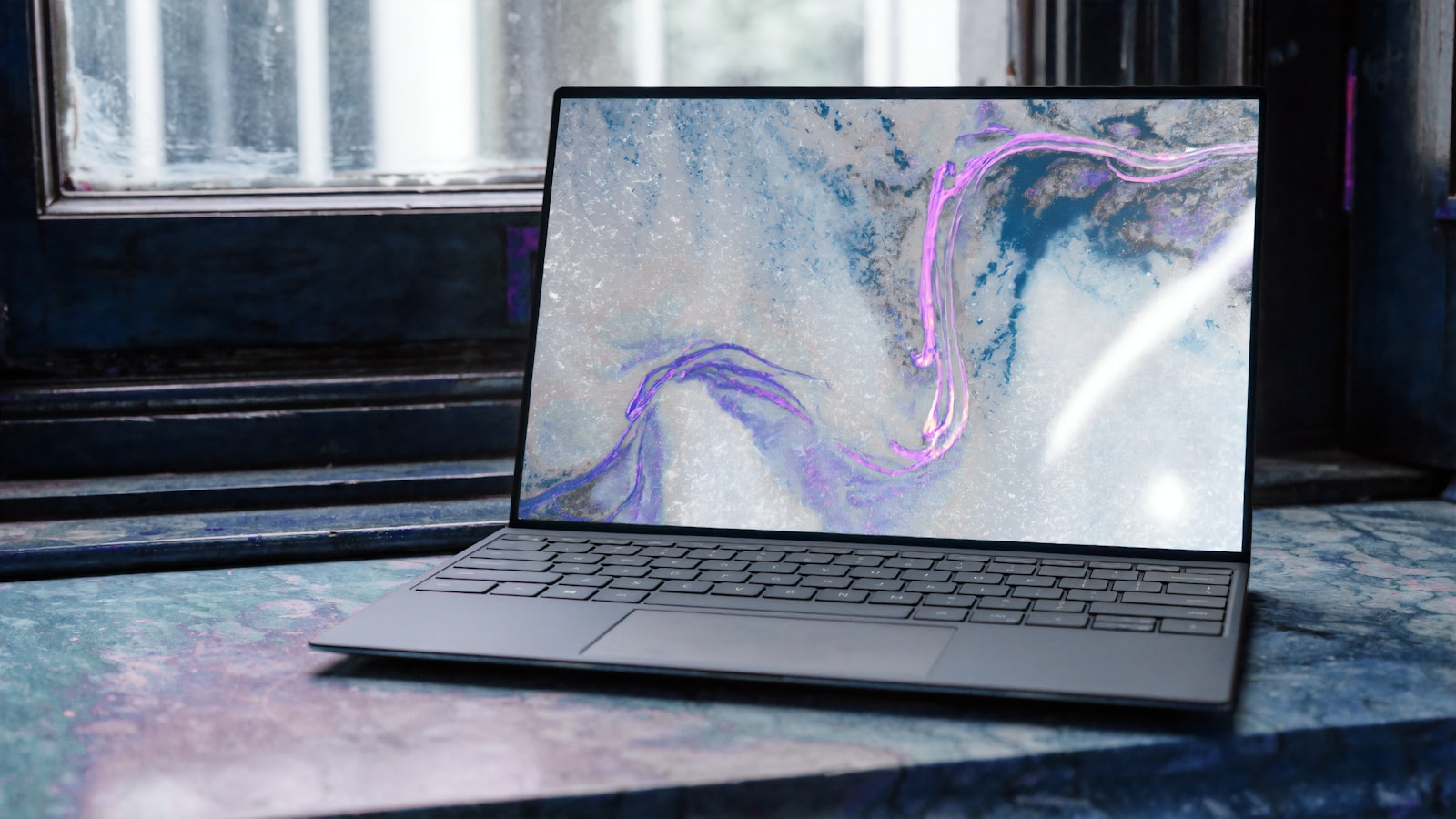 A laptop on a desk showing code